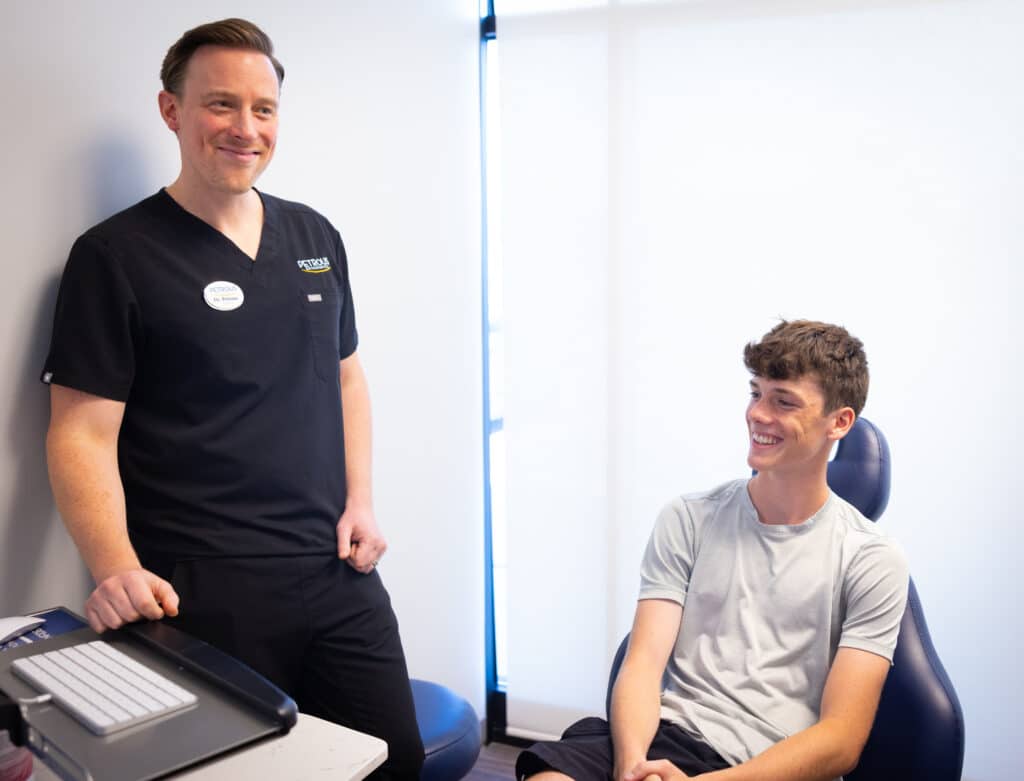 Orthodontist Smiling with Teen Patient at Petrous Orthodontics in Royal Oak, MI
